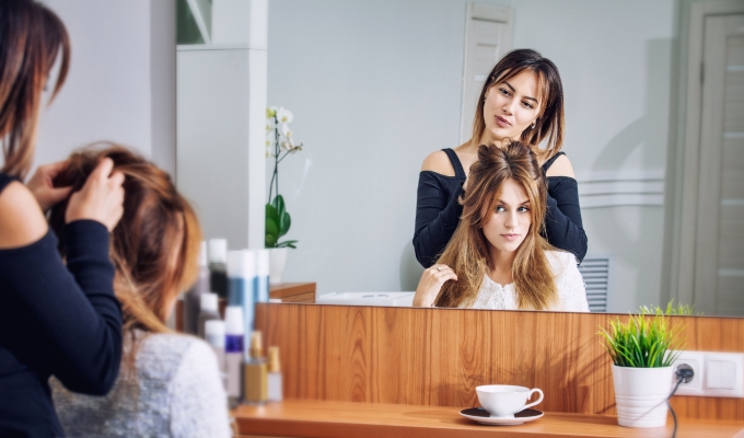 Salon client receiving hair style consultation